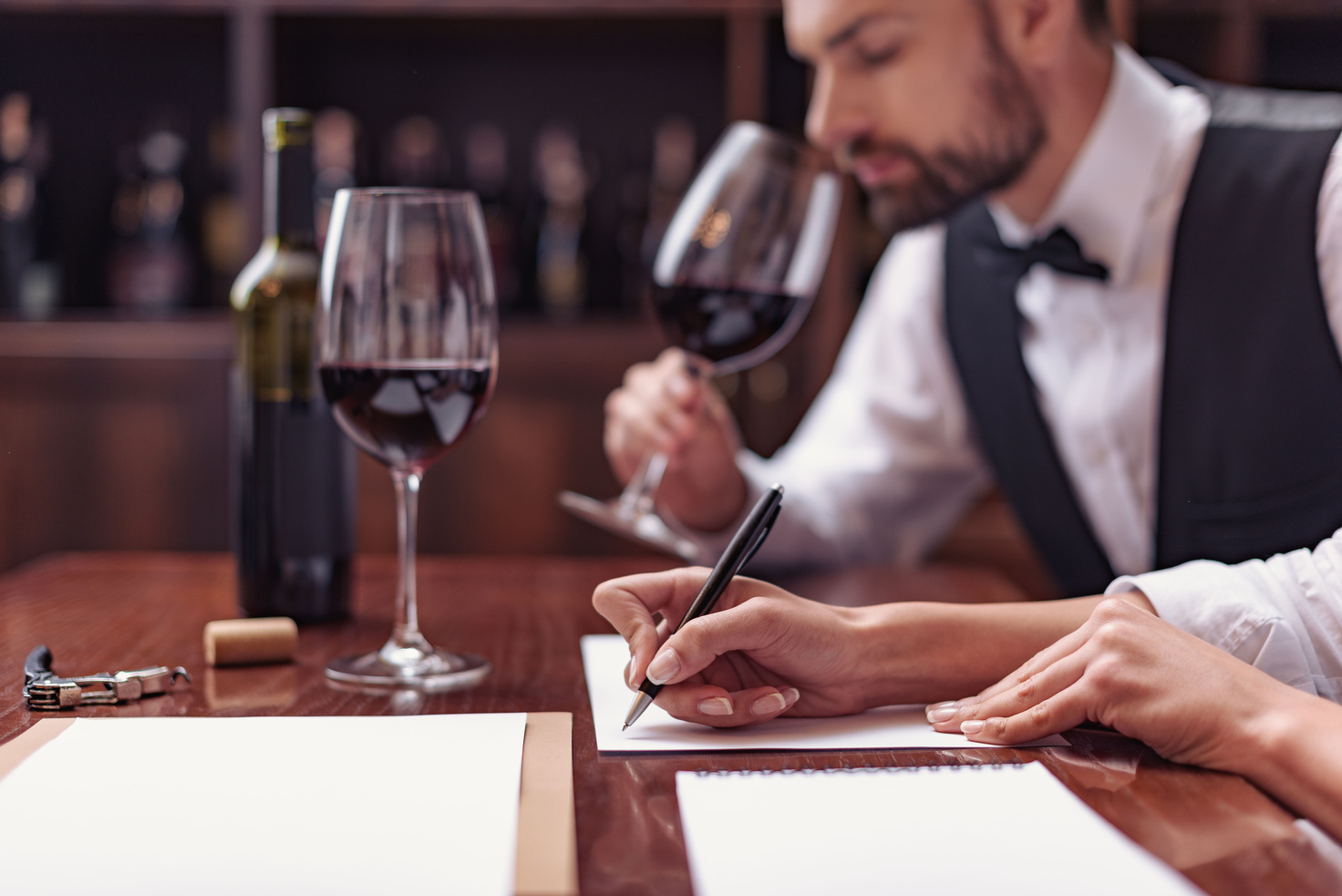 Sommeliers tasting wine in cellar