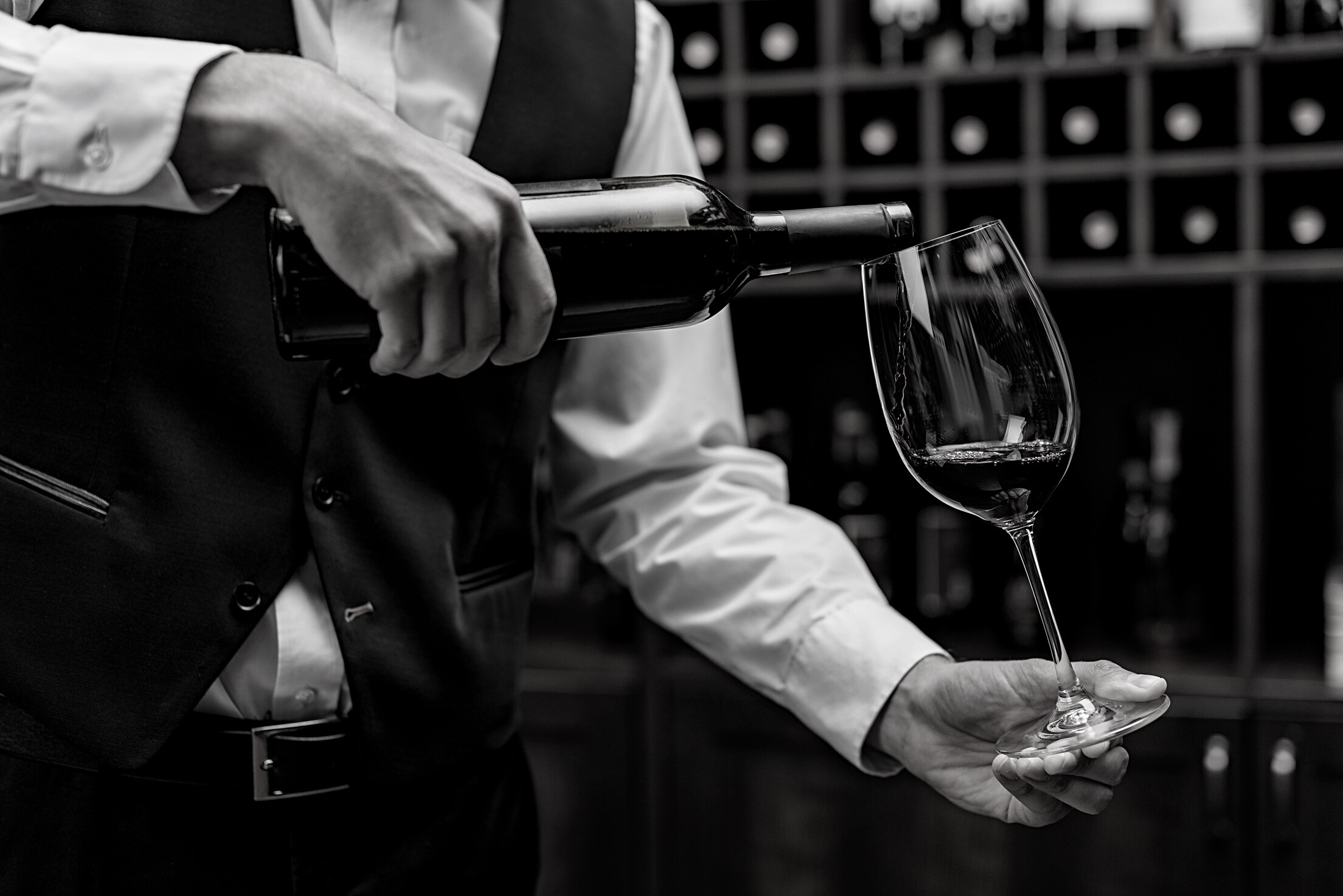 sommelier pouring red wine